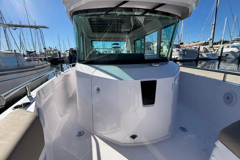 2022 Axopar 28 AFT CABIN boat docked at marina, showcasing sleek design and spacious cabin.