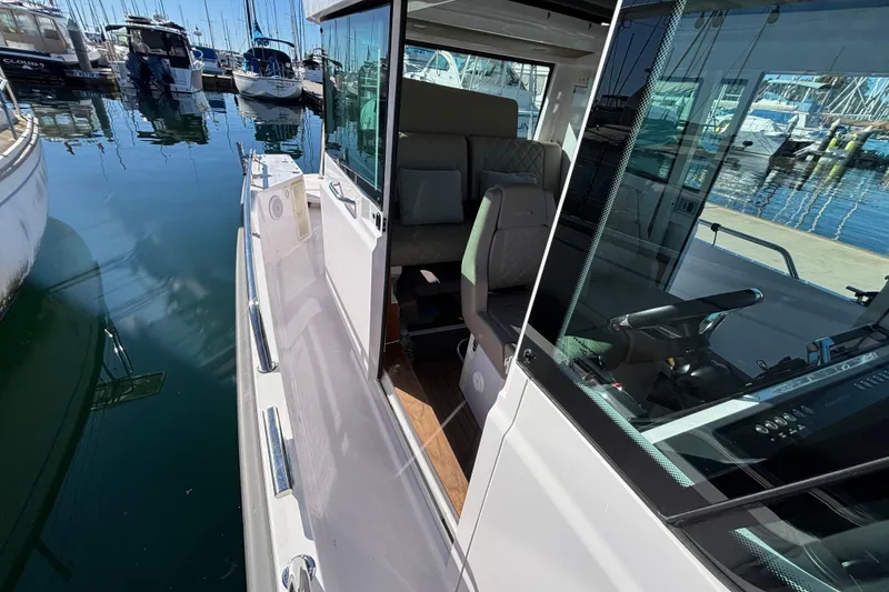 2022 Axopar 28 AFT CABIN boat docked, showcasing sleek design and modern interior.