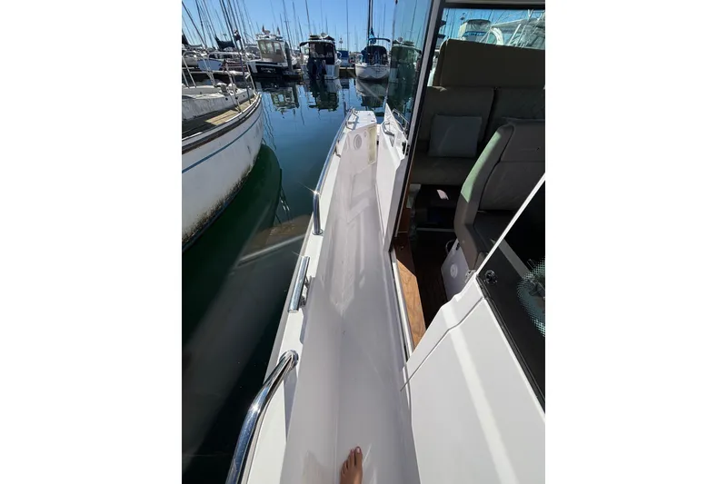 2022 Axopar 28 AFT CABIN boat docked, showing side walkway and interior seating.