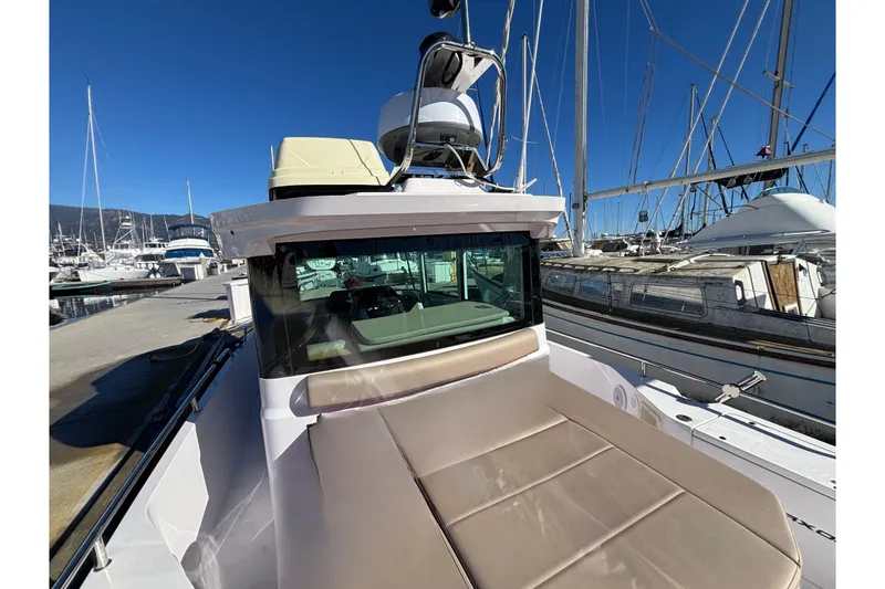 2022 Axopar 28 AFT CABIN boat docked at marina under clear blue sky.