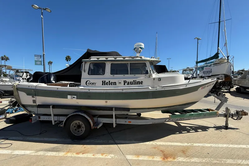 1996 C-Dory 22 boat named "Helen Pauline" on trailer at marina.
