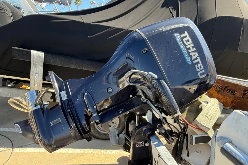 Tohatsu outboard motor on a 1996 C-Dory 22 boat, parked on a trailer.