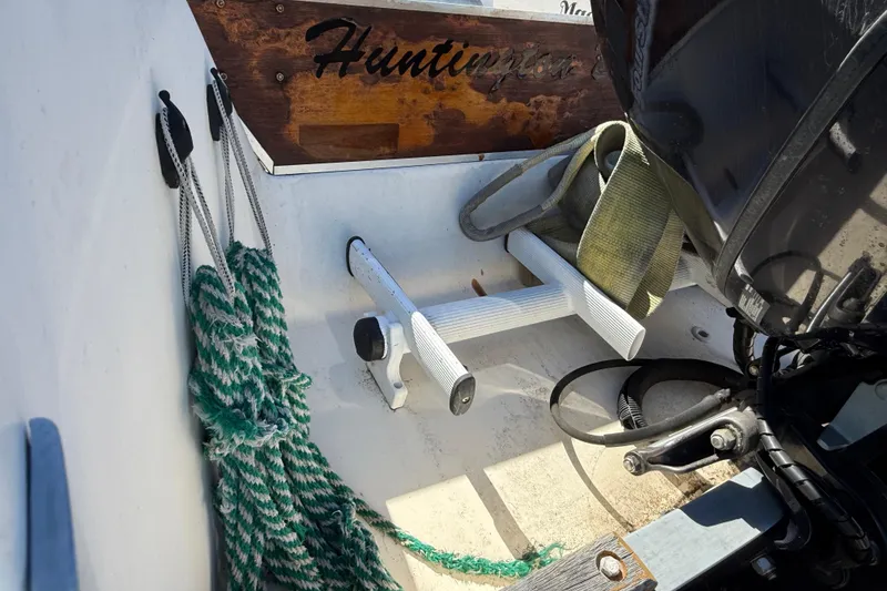 Interior of a 1996 C-Dory 22 boat with ropes and motor details.