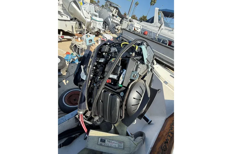 1996 C-Dory 22 boat engine exposed for maintenance in a marina setting.