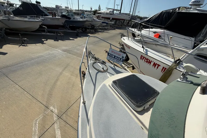 1996 C-Dory 22 boat for sale in marina, surrounded by other vessels.