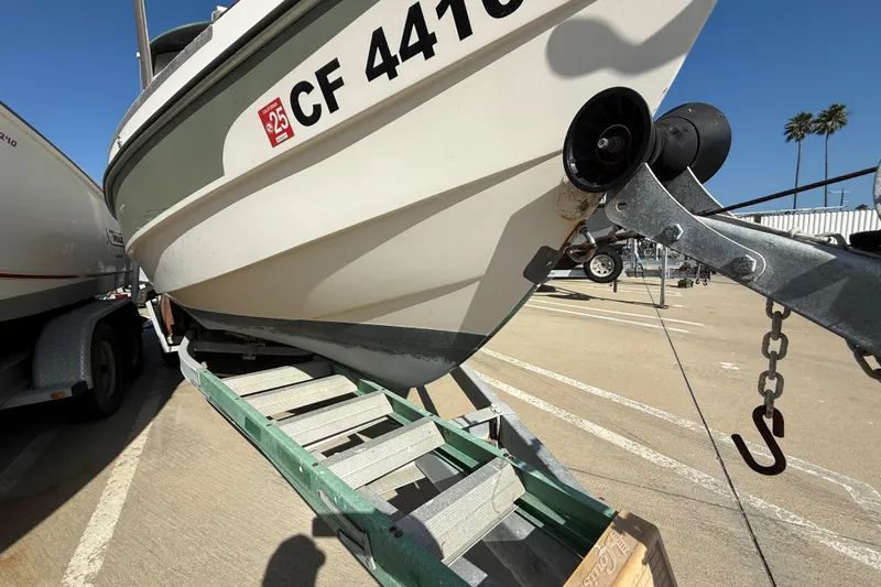 1996 C-Dory 22 boat on trailer in sunny marina setting.