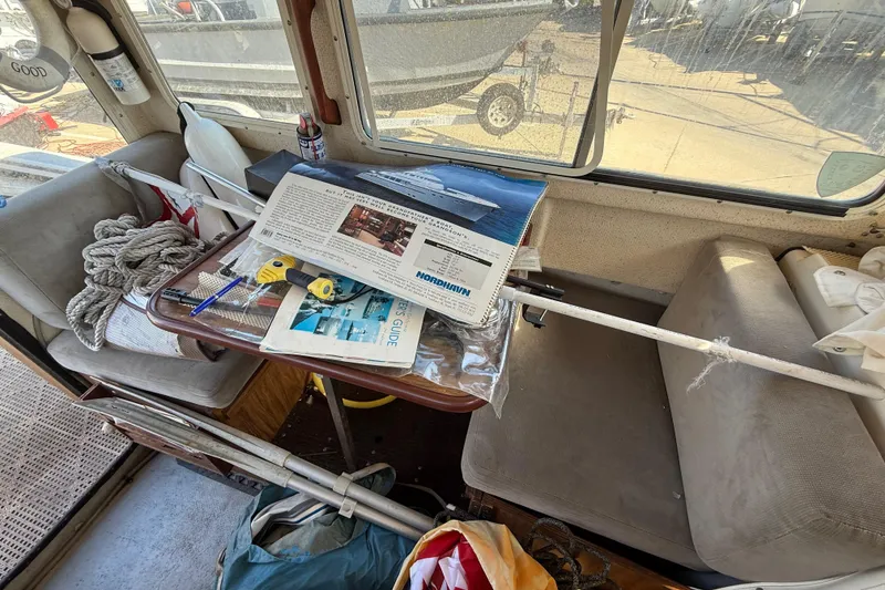 Interior of a 1996 C-Dory 22 boat with nautical equipment and manuals.