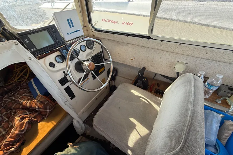1996 C-Dory 22 boat interior with steering wheel, navigation equipment, and cozy seating.