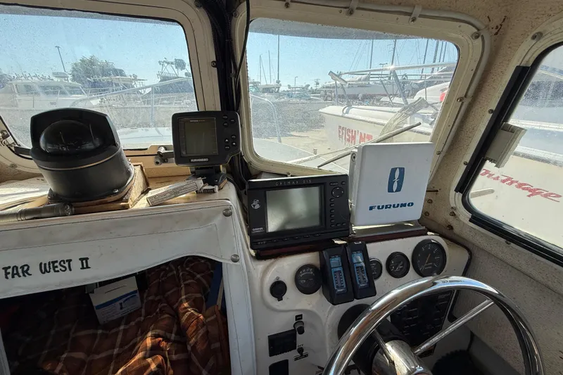 1996 C-Dory 22 boat cockpit with navigation equipment and steering wheel.