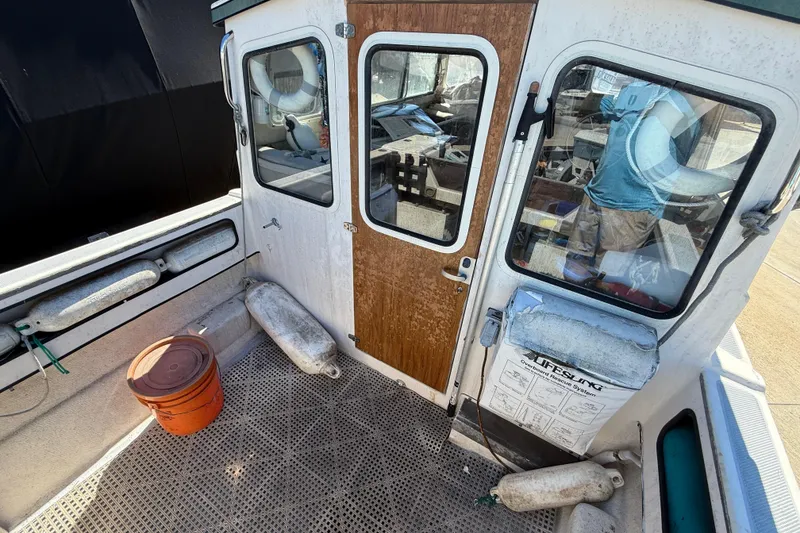1996 C-Dory 22 boat deck with cabin, life preserver, and safety equipment.