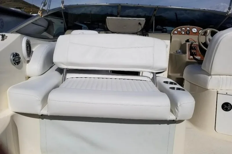 2000 Bayliner 2655 Ciera Sunbridge interior with white seating and dashboard view.