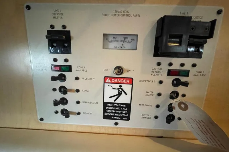 Control panel of a 2000 Bayliner 2655 Ciera Sunbridge boat, showing power switches and warnings.