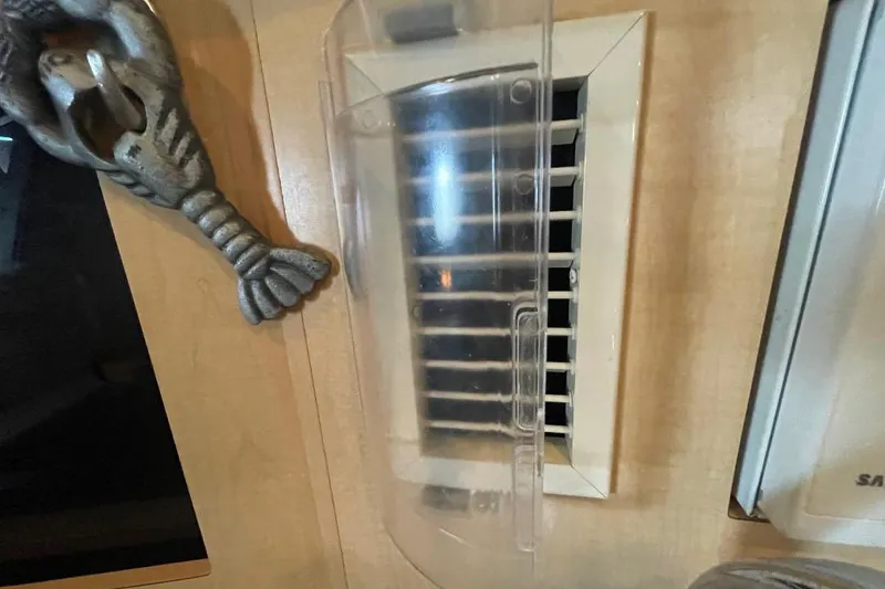 Air vent and decorative element inside 2000 Bayliner 2655 Ciera Sunbridge boat cabin.
