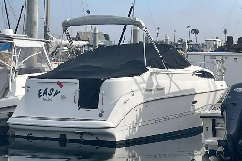 2000 Bayliner 2655 Ciera Sunbridge boat docked with black cover.