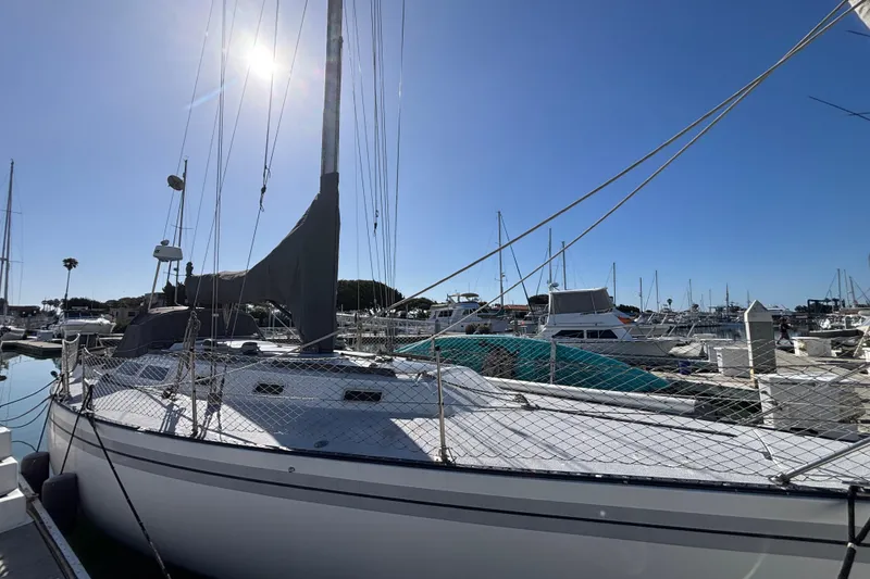 1979 Islander Peterson 40 sailboat docked in a sunny marina.