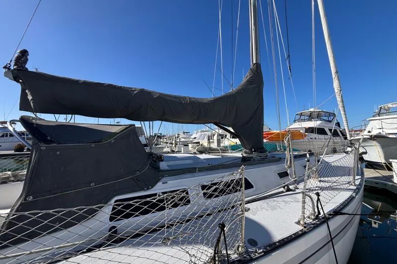 1979 Islander Peterson 40 sailboat docked at marina under clear blue sky.