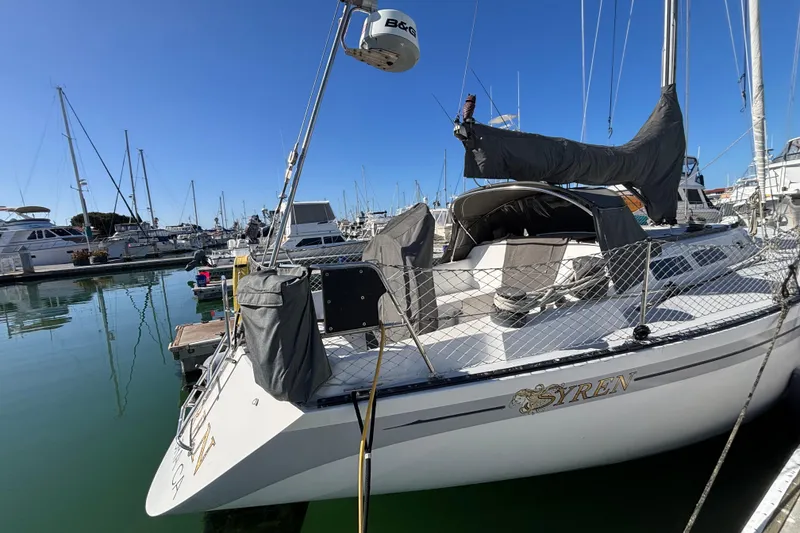 1979 Islander Peterson 40 sailboat docked in a marina under clear blue skies.