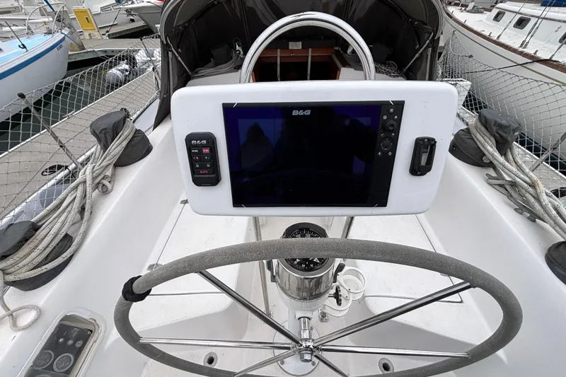 Cockpit of 1979 Islander Peterson 40 sailboat with navigation equipment and steering wheel.