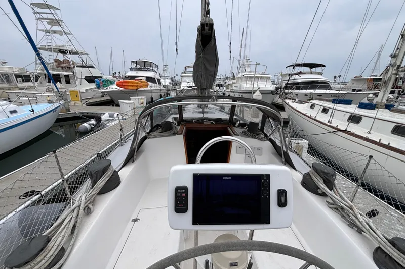 Cockpit view of 1979 Islander Peterson 40 sailboat docked in a marina.