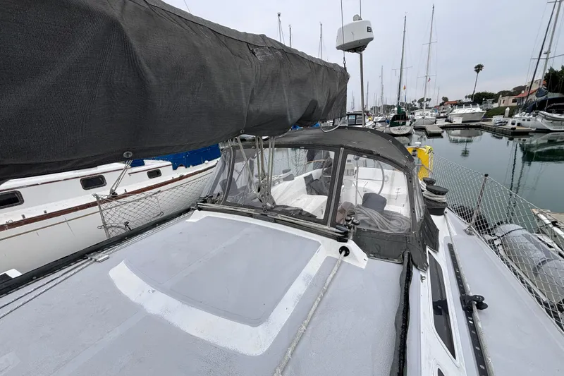 1979 Islander Peterson 40 sailboat docked in a marina, featuring a covered cockpit and sleek design.