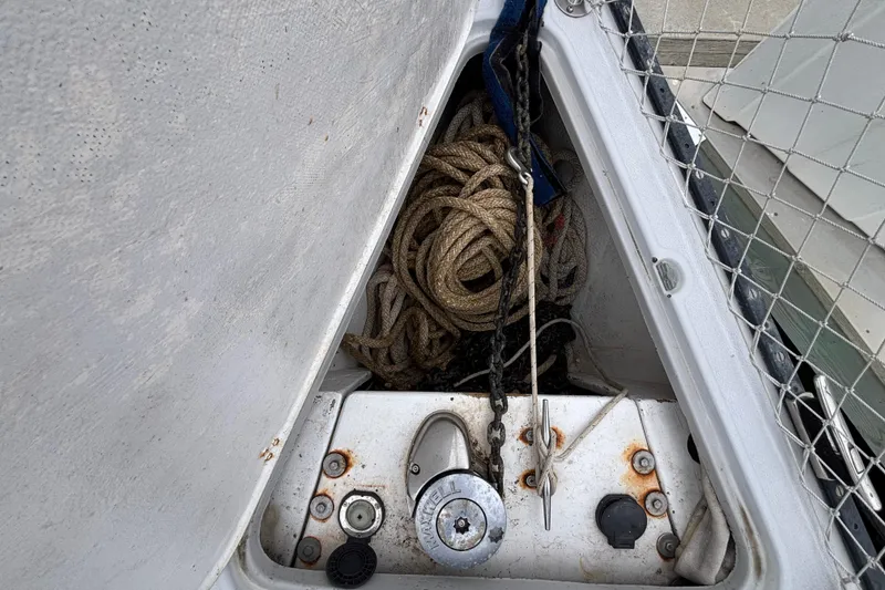 Anchor locker of 1979 Islander Peterson 40 sailboat with ropes and lock.