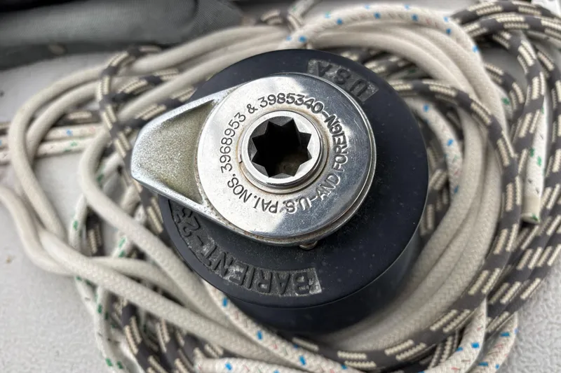 Winch mechanism on 1979 Islander Peterson 40 sailboat with coiled ropes.