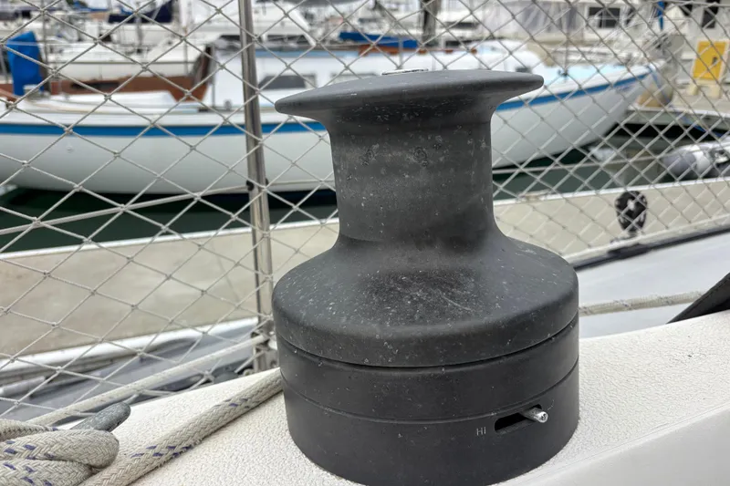Winch on 1979 Islander Peterson 40 sailboat, docked with other boats in background.