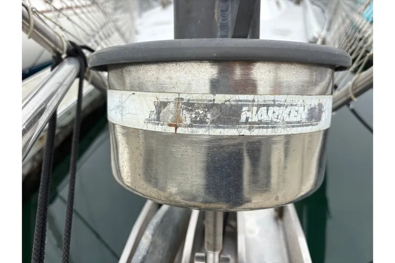Close-up of a weathered Harken winch on a 1979 Islander Peterson 40 sailboat.