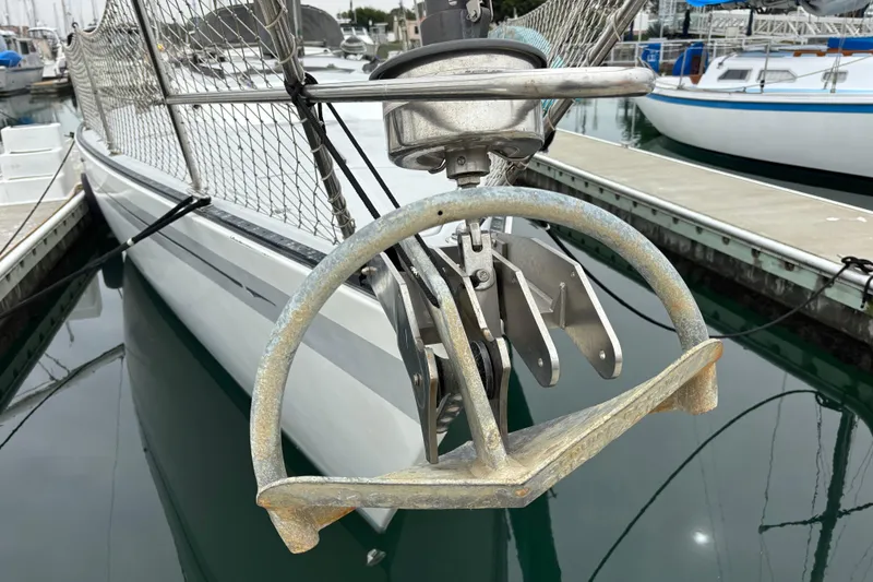 1979 Islander Peterson 40 sailboat with anchor, docked in marina.