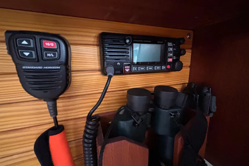 Radio and binoculars on 1979 Islander Peterson 40 yacht's wooden interior.