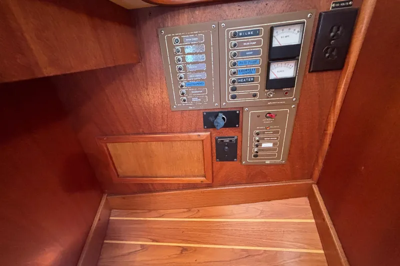 Electrical control panel on 1979 Islander Peterson 40 sailboat, featuring switches and gauges.
