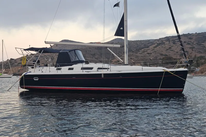 2004 Hunter 41 Aft Cockpit sailboat anchored in scenic coastal waters.