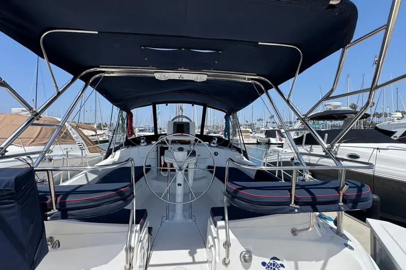 2004 Hunter 41 Aft Cockpit sailboat interior with steering wheel, docked at marina.