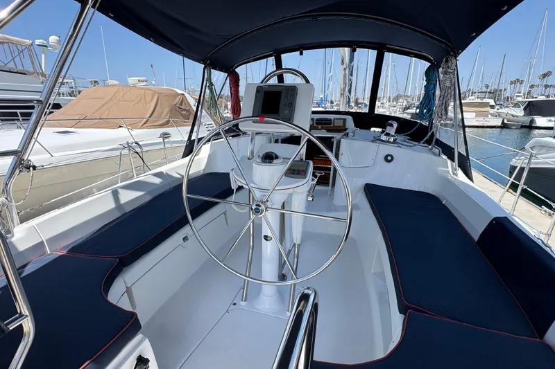 2004 Hunter 41 Aft Cockpit sailboat interior with steering wheel and navigation equipment.
