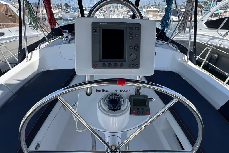 Steering wheel and navigation equipment on a 2004 Hunter 41 Aft Cockpit sailboat.