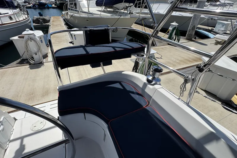 2004 Hunter 41 Aft Cockpit sailboat with navy cushions docked at marina.