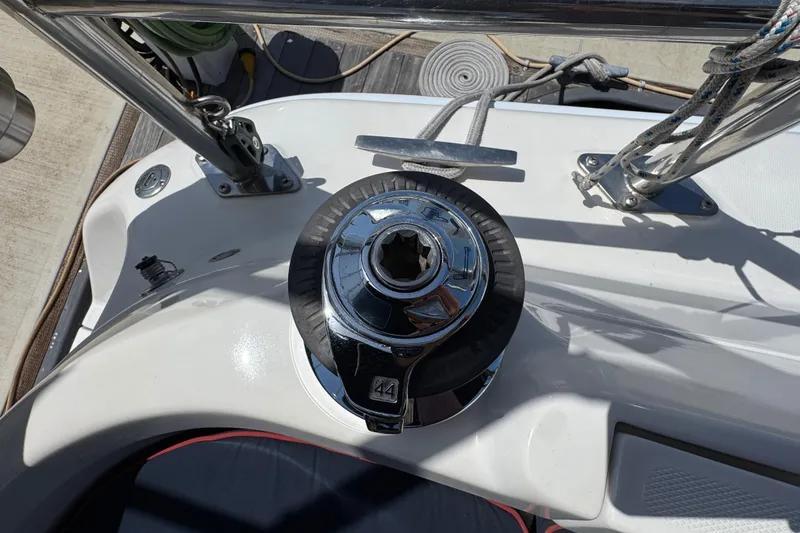 Winch on 2004 Hunter 41 Aft Cockpit sailboat deck, with ropes and fittings.
