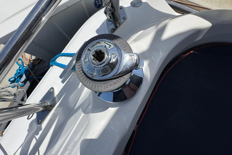 Winch on 2004 Hunter 41 Aft Cockpit sailboat, with ropes and stainless steel fittings.