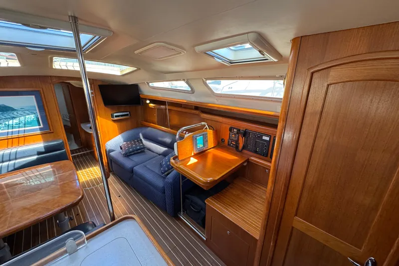 Interior of 2004 Hunter 41 Aft Cockpit yacht with wood finish and seating area.