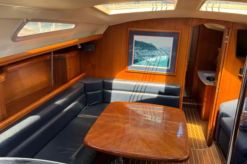 Interior of 2004 Hunter 41 Aft Cockpit yacht with wood finish and seating area.