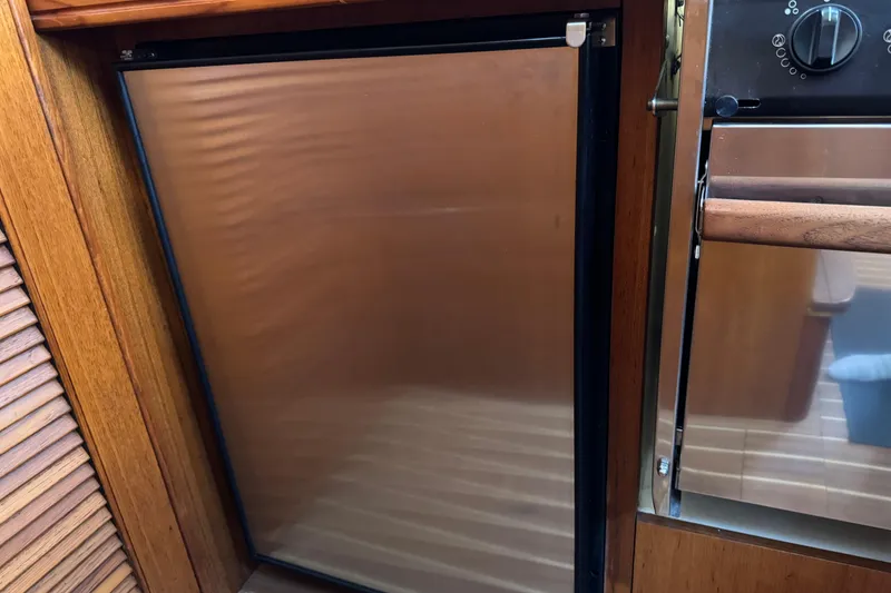 Stainless steel fridge in 2004 Hunter 41 Aft Cockpit yacht kitchen.