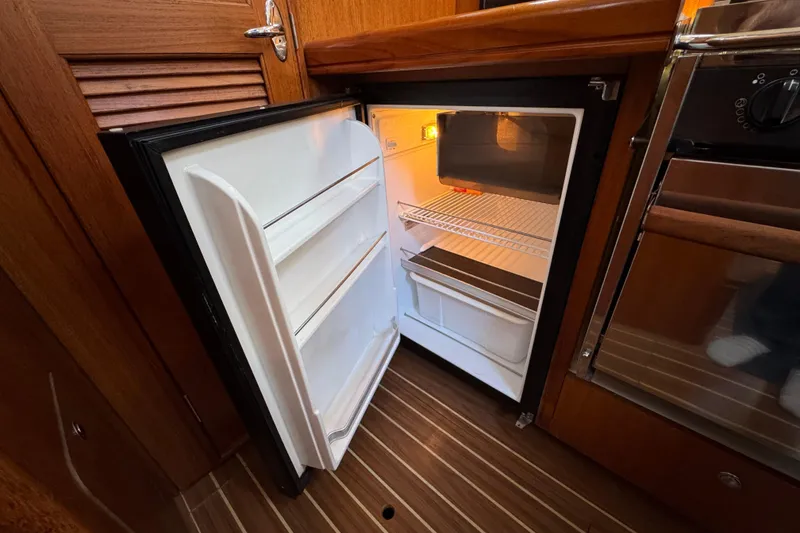 Open refrigerator in the galley of a 2004 Hunter 41 Aft Cockpit sailboat.