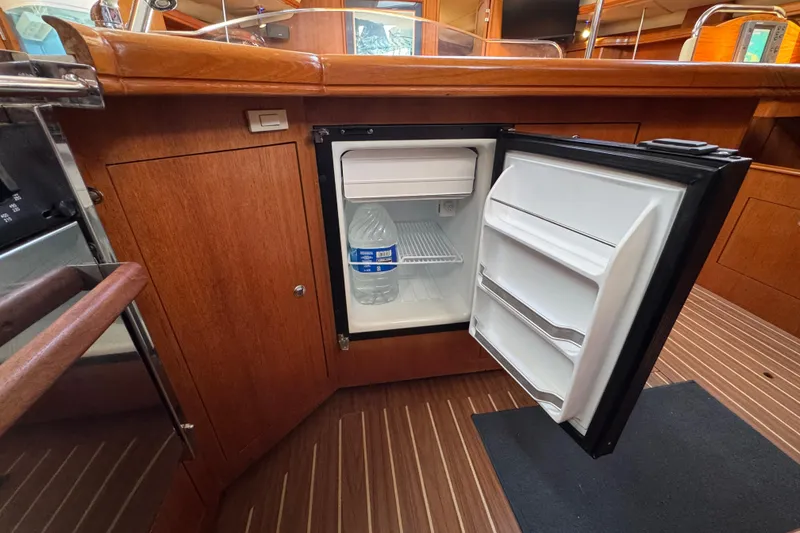 Open mini fridge in 2004 Hunter 41 Aft Cockpit yacht interior.
