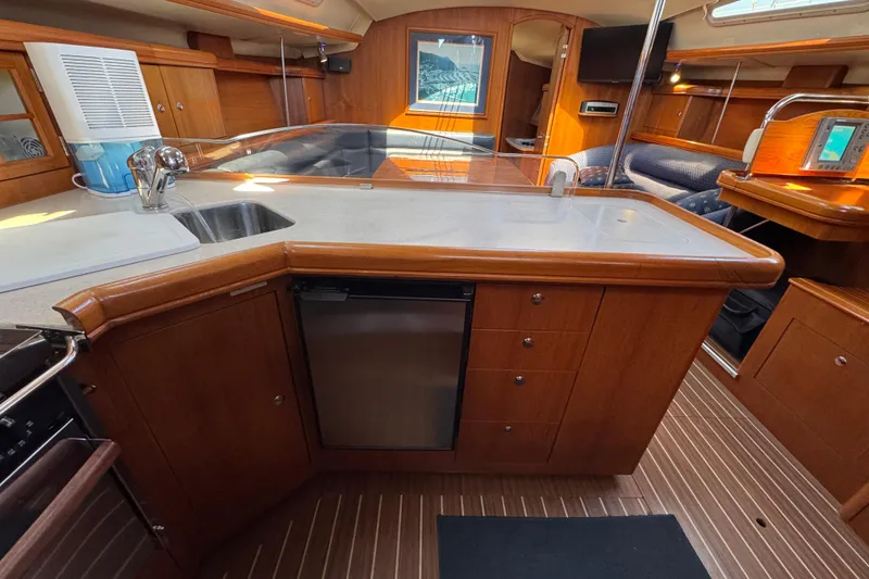 Luxurious 2004 Hunter 41 Aft Cockpit yacht interior with modern kitchen and wood finish.