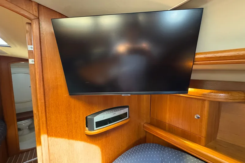 Interior of 2004 Hunter 41 Aft Cockpit yacht with mounted TV and audio system.