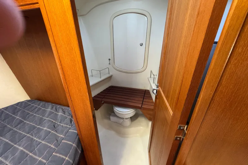 2004 Hunter 41 Aft Cockpit yacht bathroom with wooden accents and compact design.