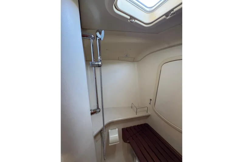 Interior shower area of 2004 Hunter 41 Aft Cockpit yacht with skylight and wooden bench.