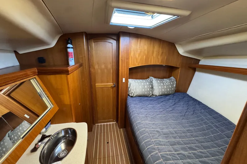 2004 Hunter 41 Aft Cockpit cabin interior with bed, sink, and wooden finishes.