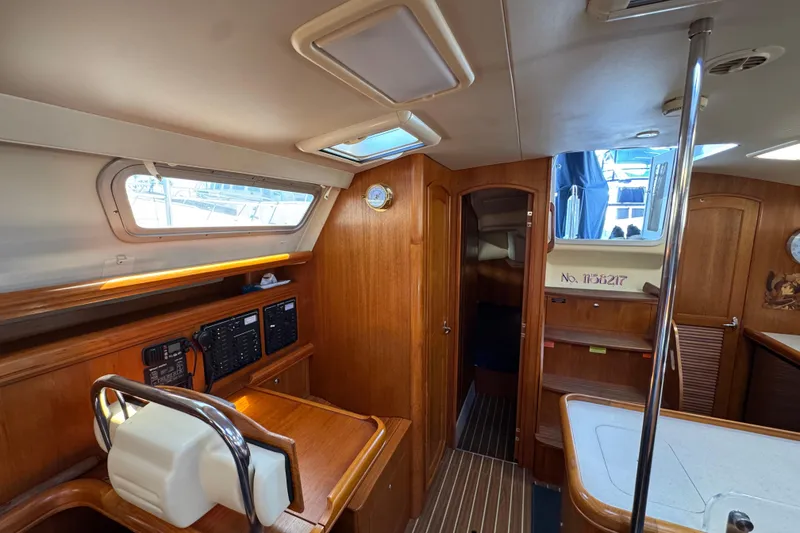 Interior of 2004 Hunter 41 Aft Cockpit sailboat with wood finish and navigation equipment.