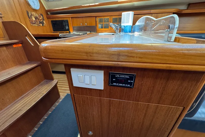 Interior of 2004 Hunter 41 Aft Cockpit yacht with wooden cabinetry and LPG control panel.